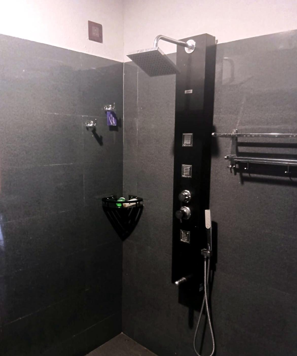 Bathroom with a black rain shower panel